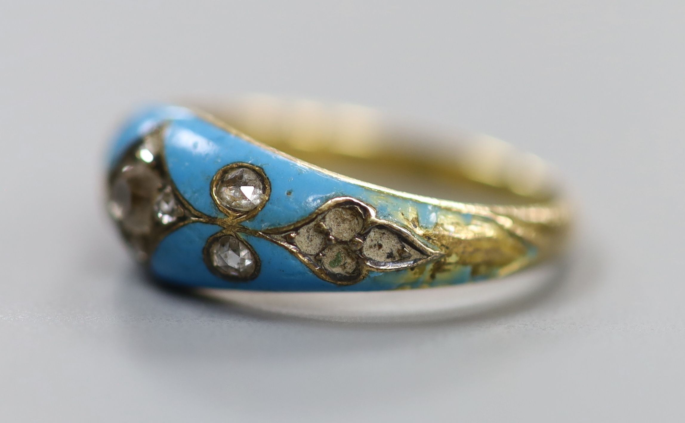 A late Victorian yellow metal, enamel and rose cut diamond set dress ring(a.f.), size L/M, gross weight 4.9 grams.